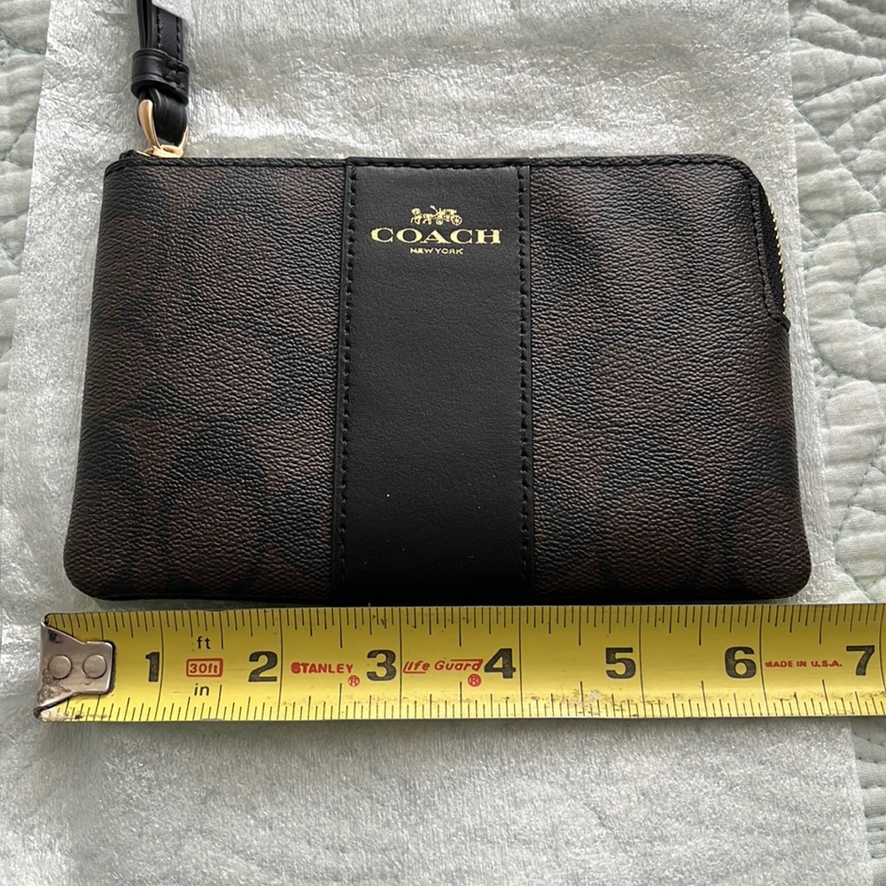 Coach black and brown wristlet.
